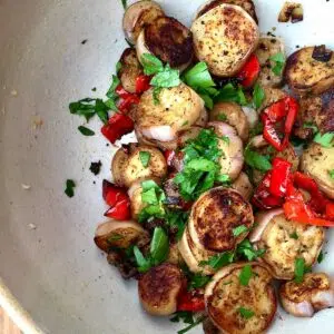 a large bowl of cooked eggplant and peppers.