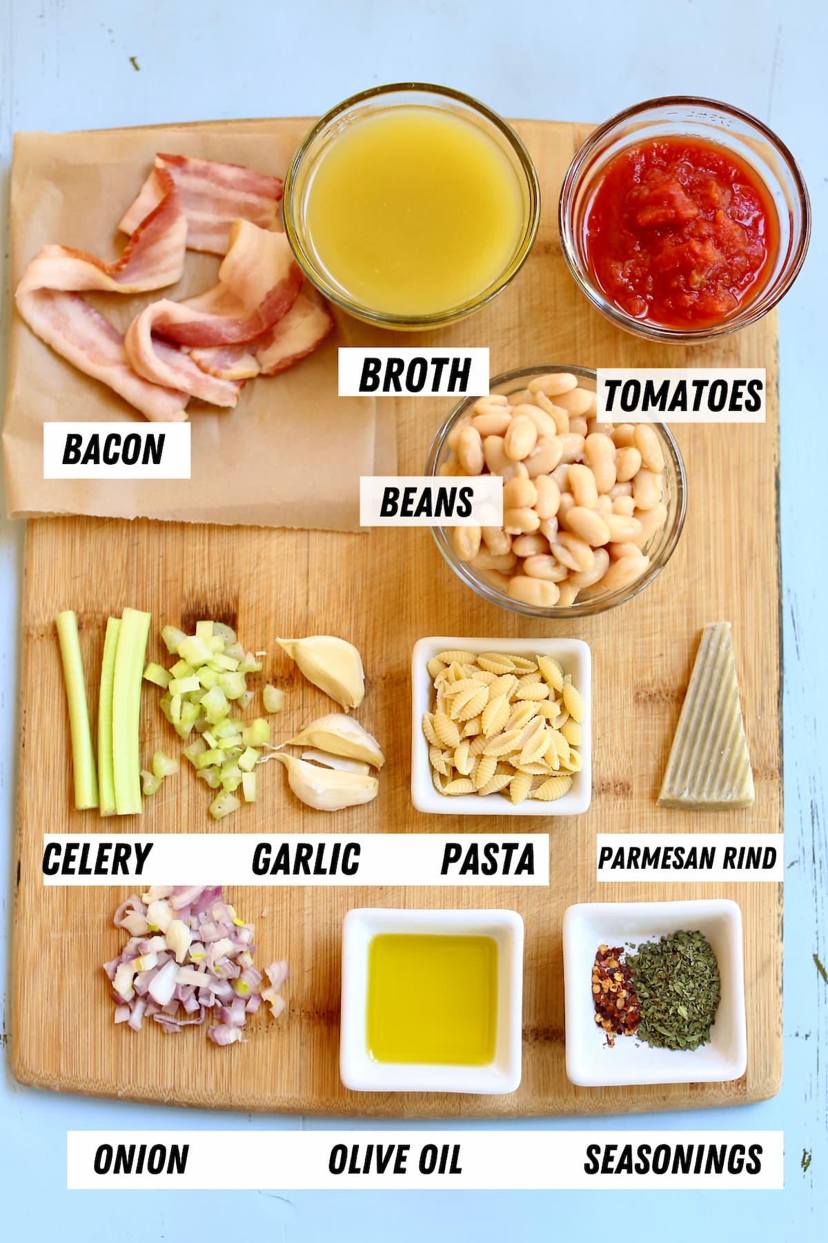 a cutting board with multiple ingredients on it for soup.