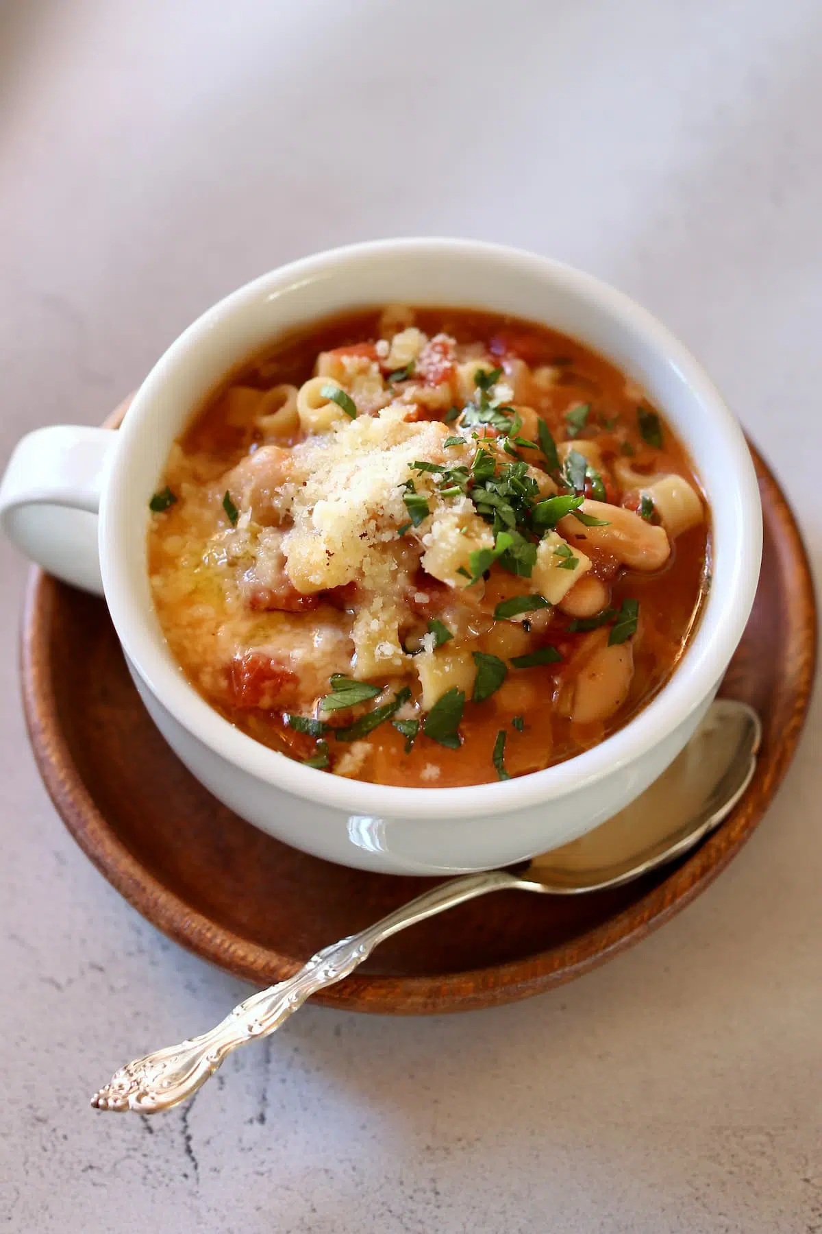a bowl of soup in the middle of a table, with a spoon.