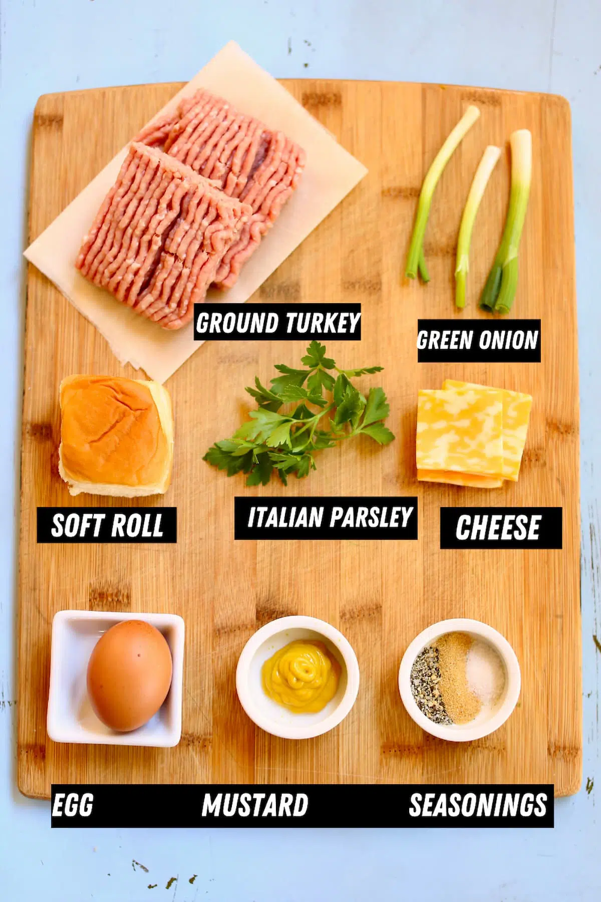 a cutting board of ingredients for turkey burger sliders