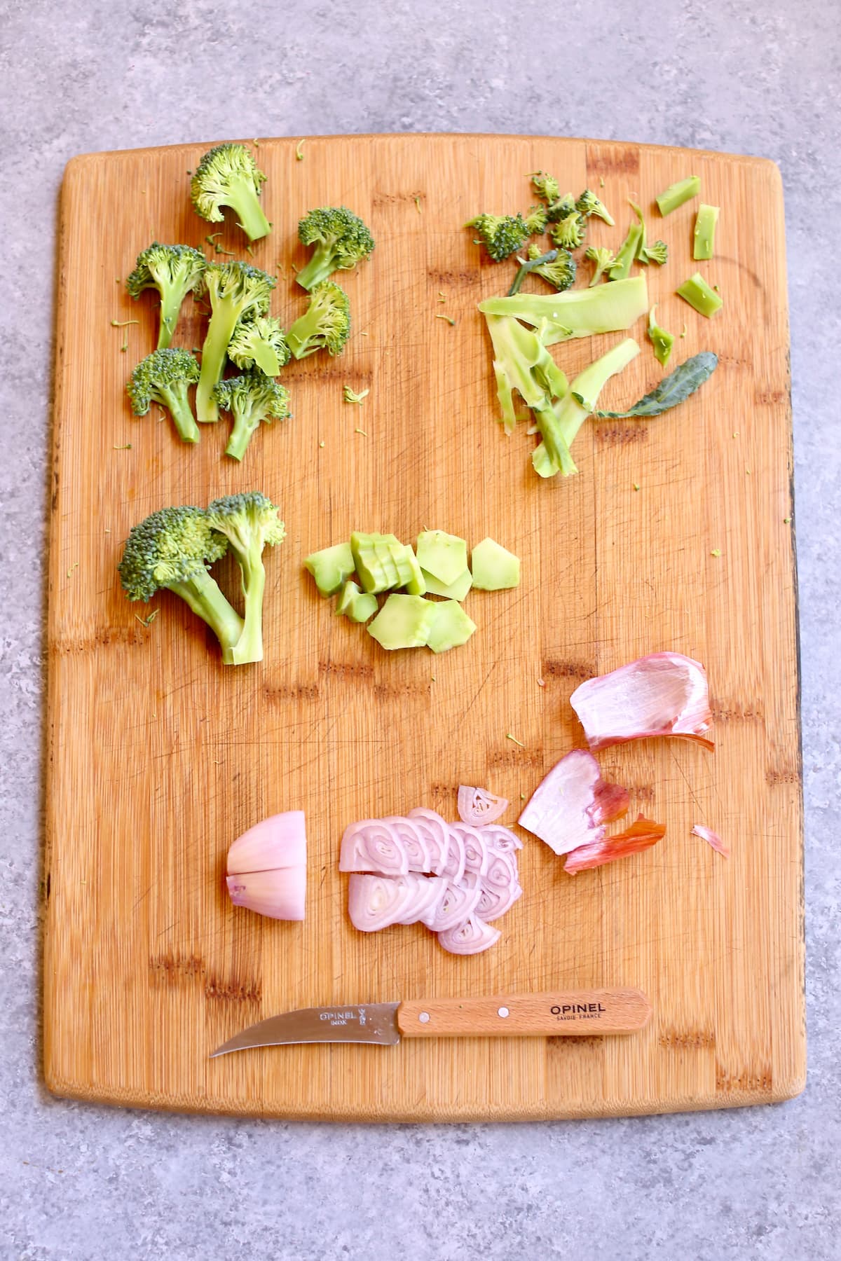a cutting board with ingredients and knife cut examples for certain vegetables shown.
