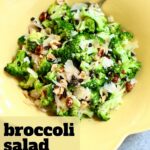 a yellow bowl of broccoli salad without bacon.
