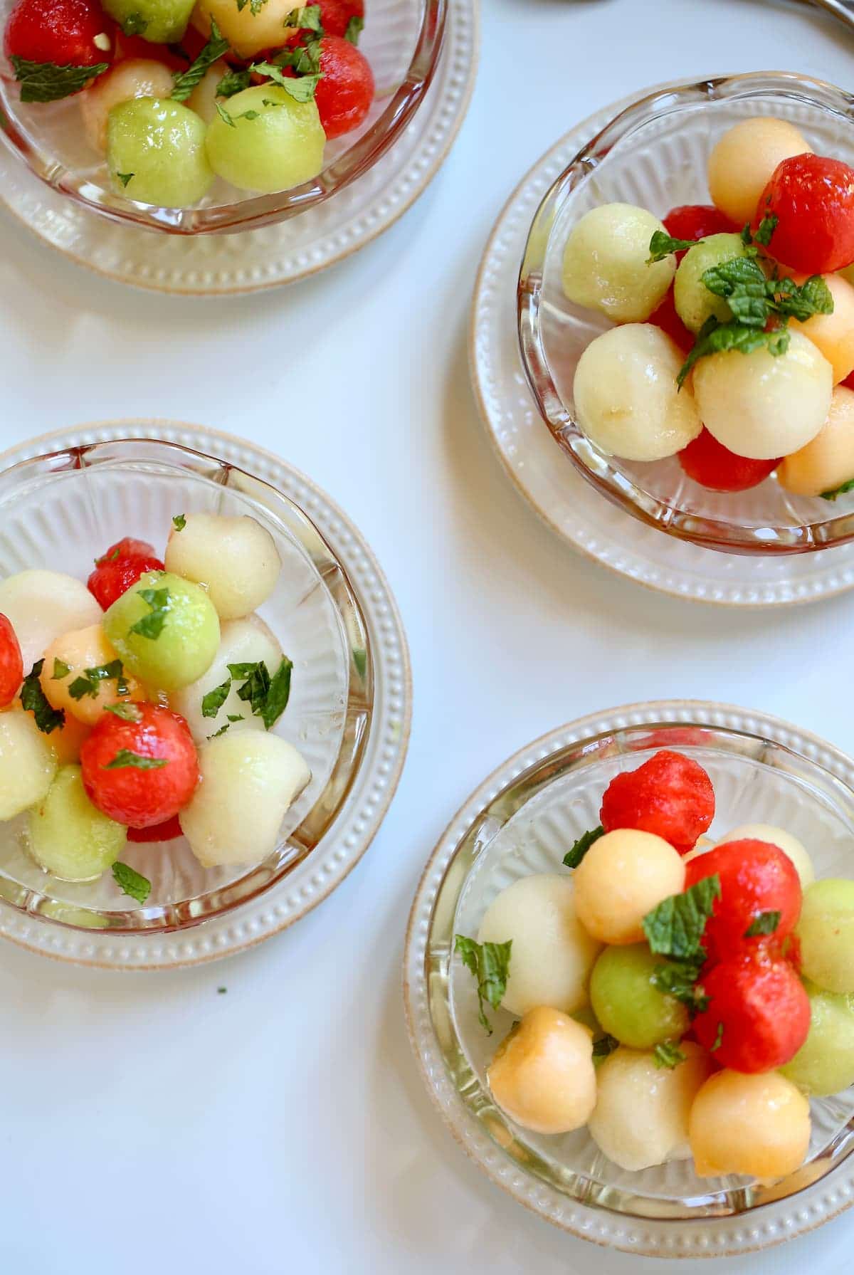 four small servings of melon salad.