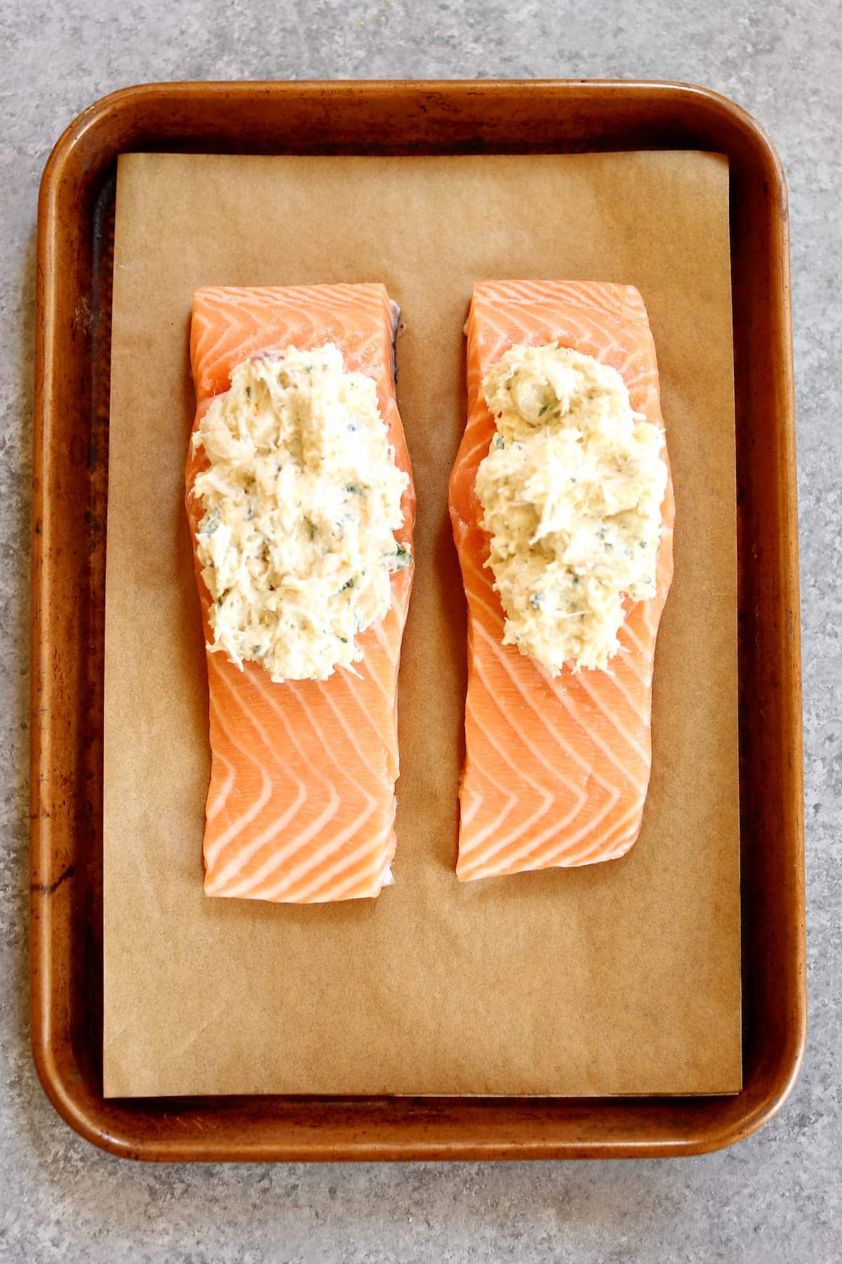 raw salmon on a baking sheet.