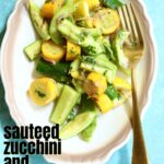 a white and tan plate of zucchini with a gold fork.