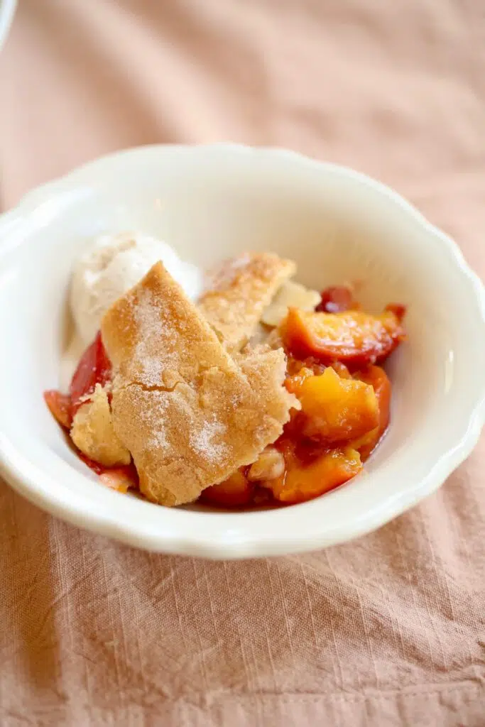 a small bowl of peach cobbler ala mode.