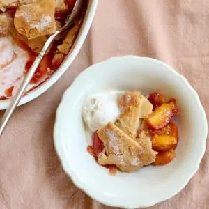 a square photo of peach cobbler.