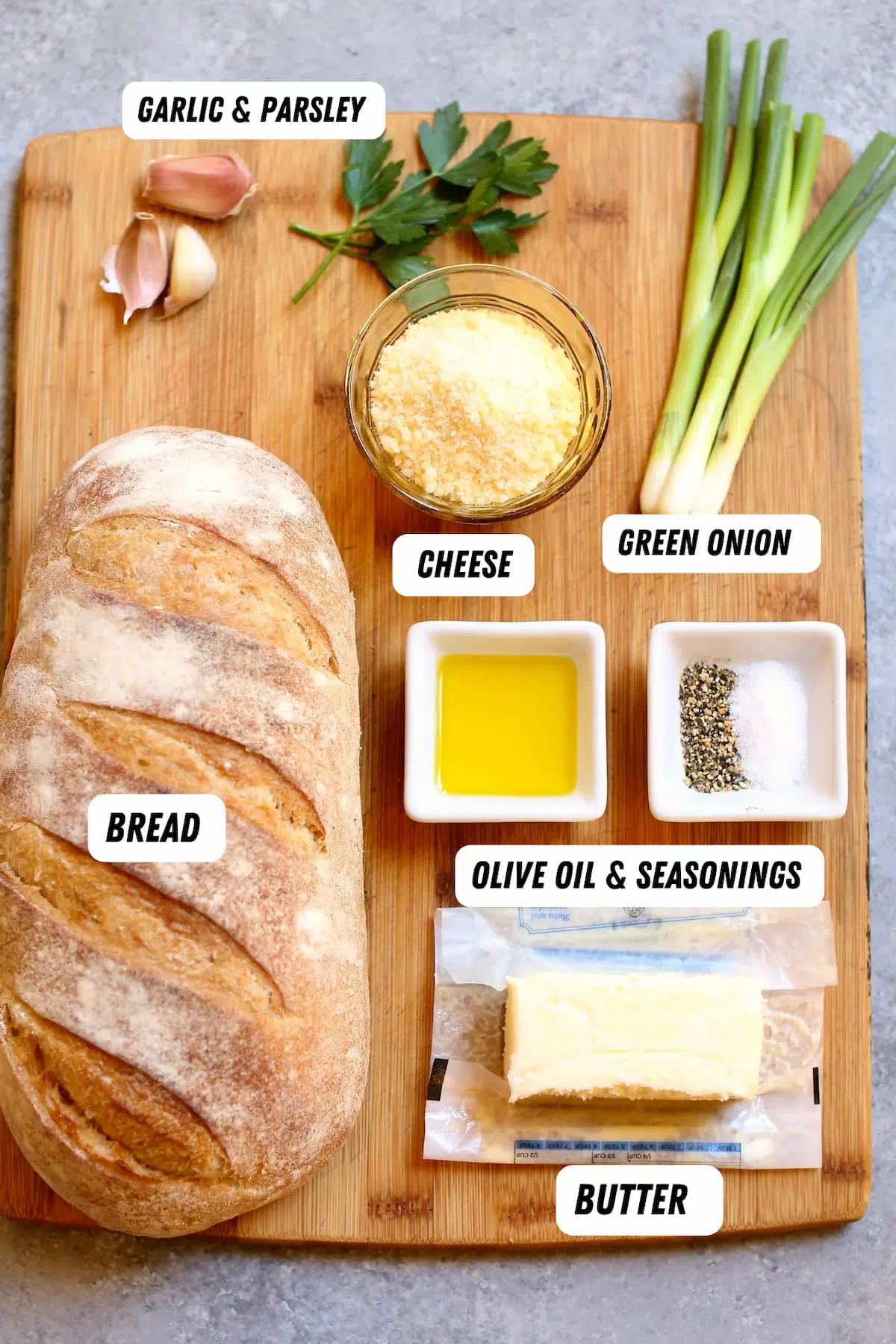 a table with ingredients for garlic bread.