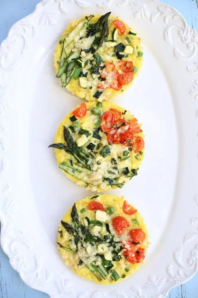 three small italian frittatas on a white plate.