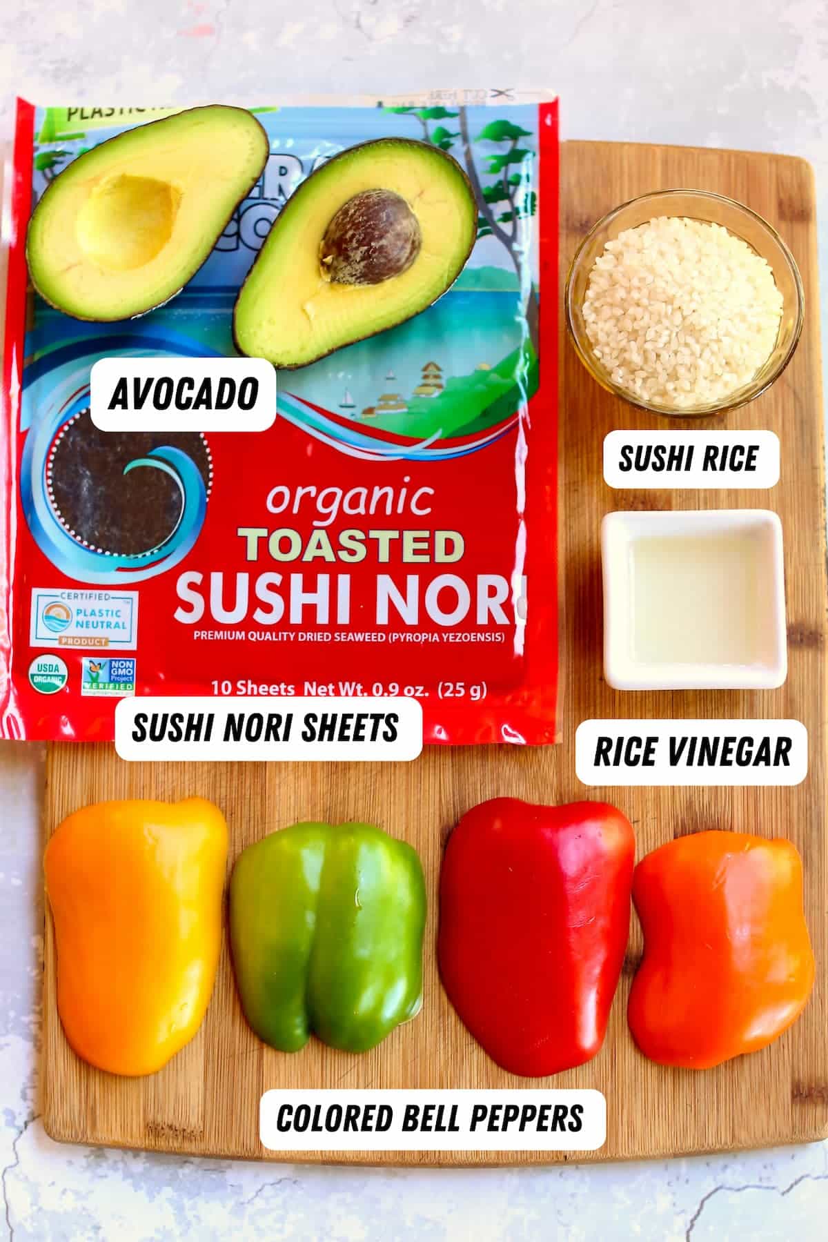a cutting board with ingredients for sushi rolls.