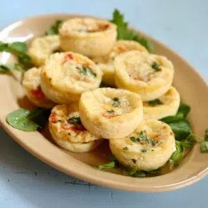 a square photo of egg bites on a serving tray.