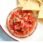 a photo of salsa on a white platter with text overlay.