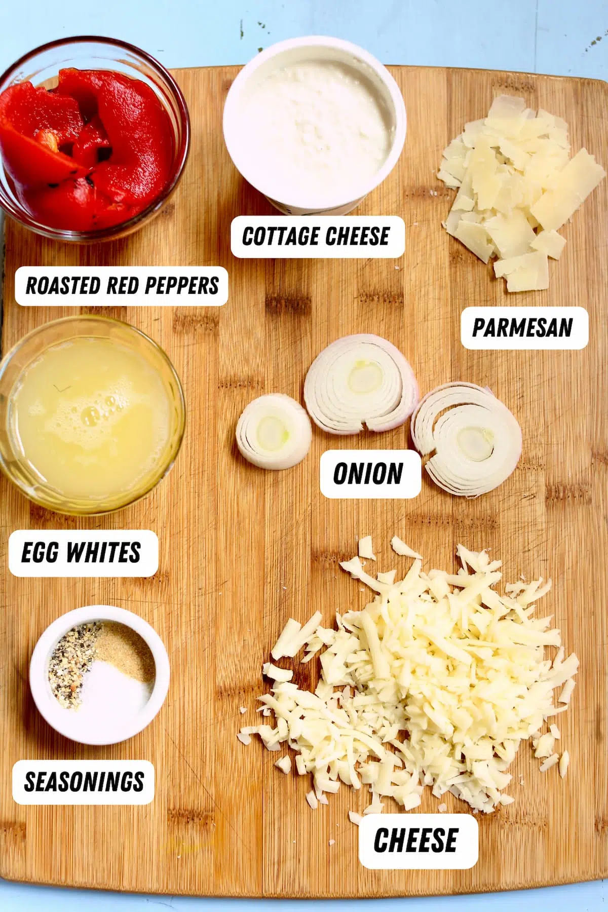 a cutting board with ingredients for eggbites on it.