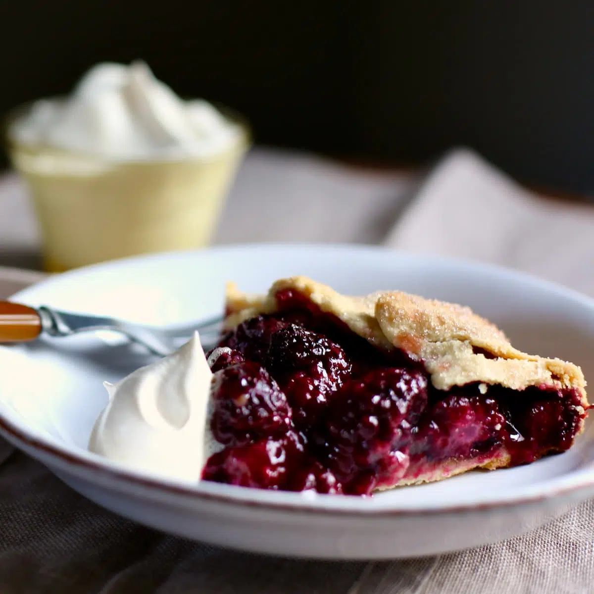 a piece of pie on a white plate.