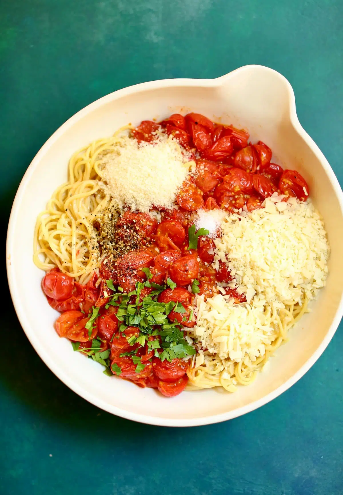 a large bowl with unmixed ingredients for spaghetti pie.
