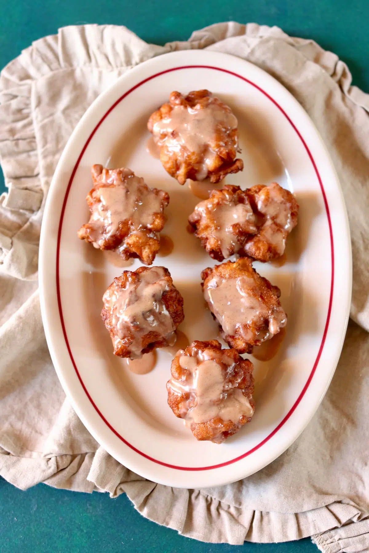 an overhead photo of apple fritters on a platter.