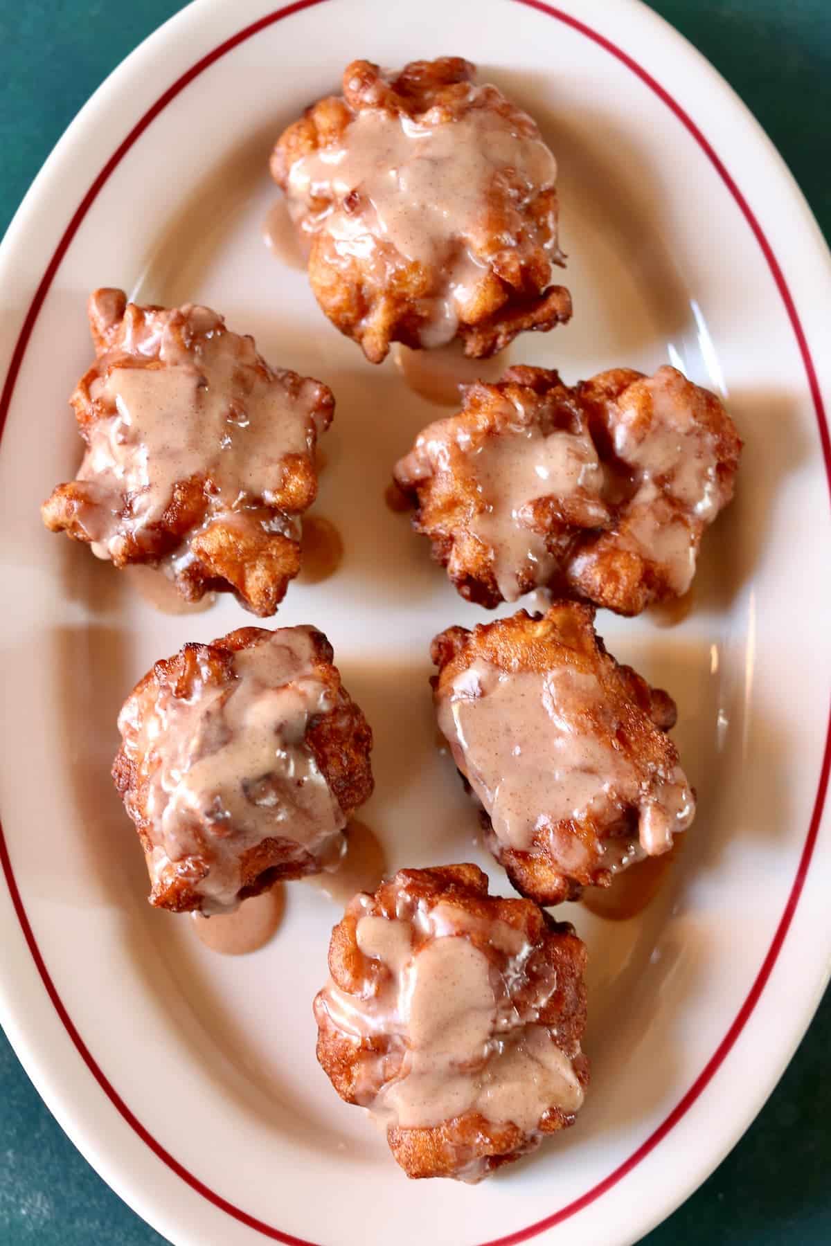 an overview photo of a platter of apple fritters.