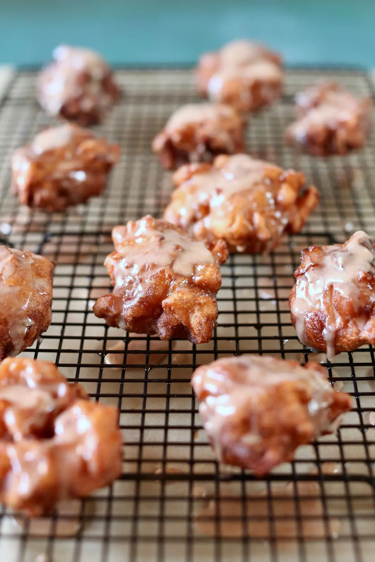 a wire rack of apple fritters.