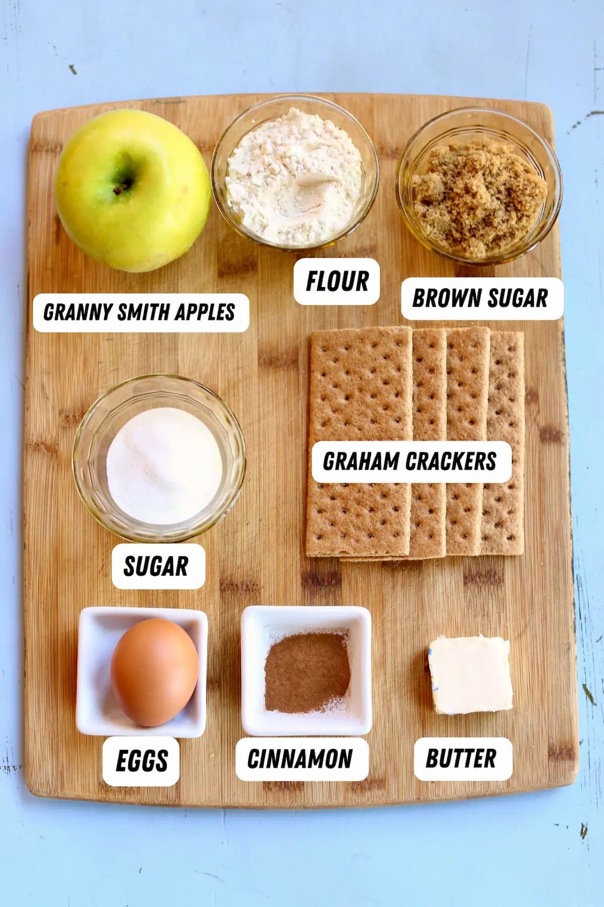 a cutting board of ingredients for apple pie.