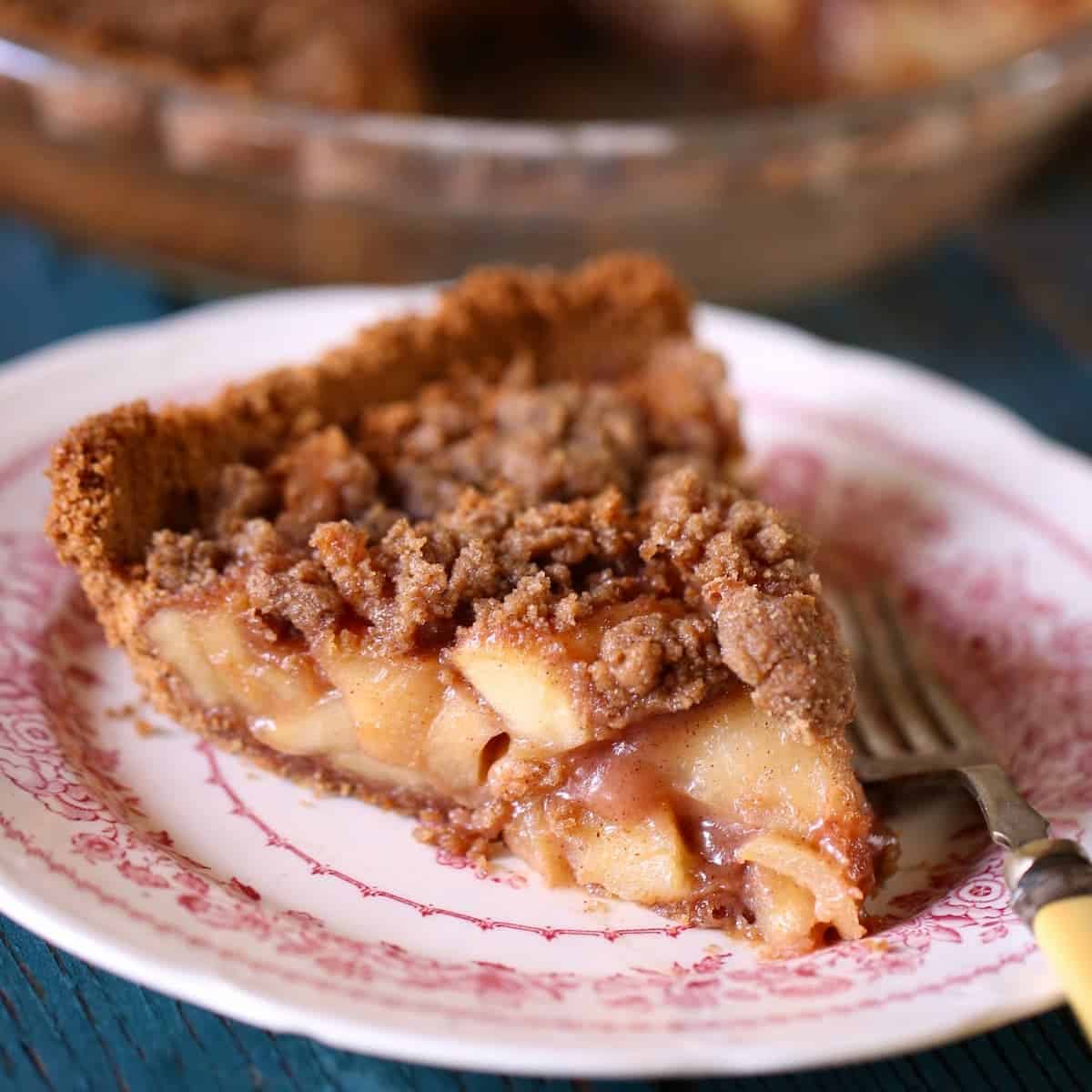 a square photo of apple pie on a plate.