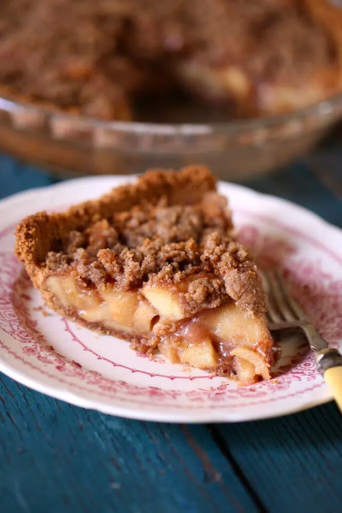 a piece of apple pie on a small plate.