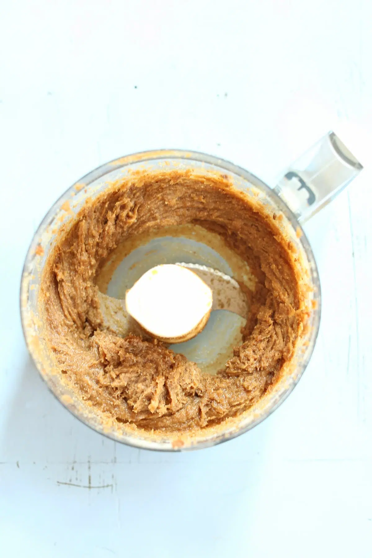 a food processor with cookie dough in it.