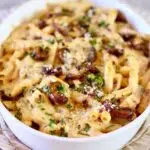 a white casserole dish of chicken pasta.