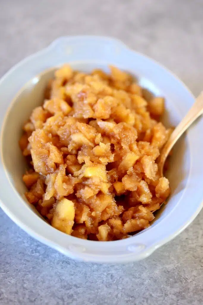 a blue bowl of applesauce.