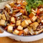 a pin of a photo of tofu & eggplant with text overlay saying the recipe name.