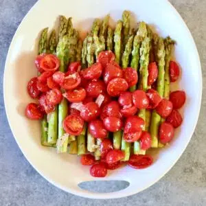 a square image of a platter of asparagus.