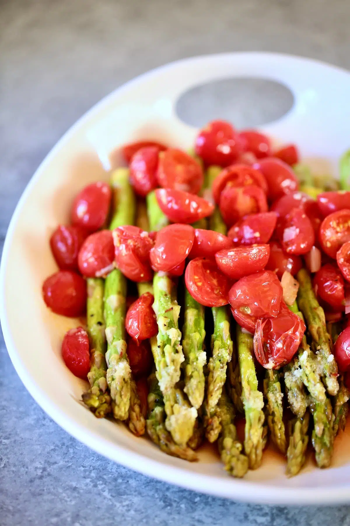 a side view of asparagus with tomatoes.