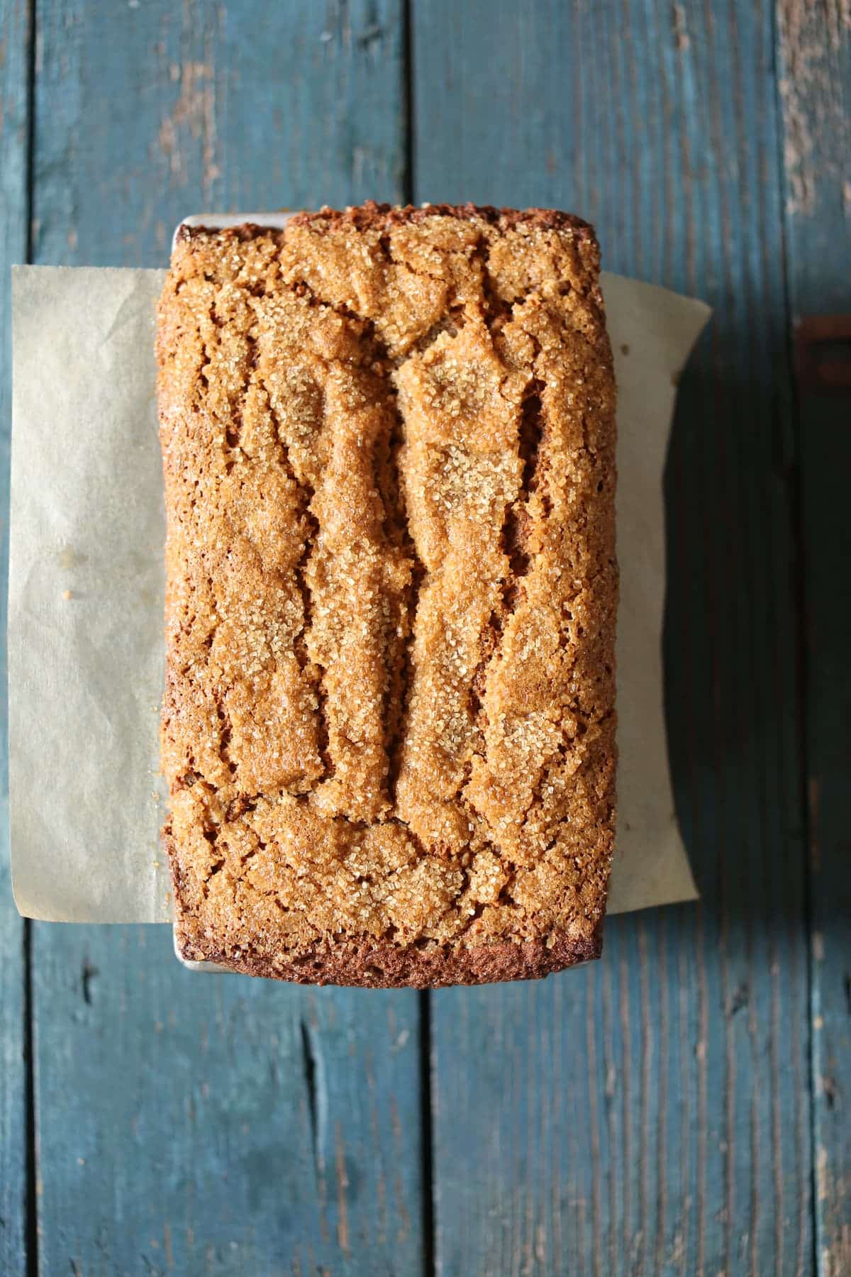 a photo of a banana bread on a blue wooden table.