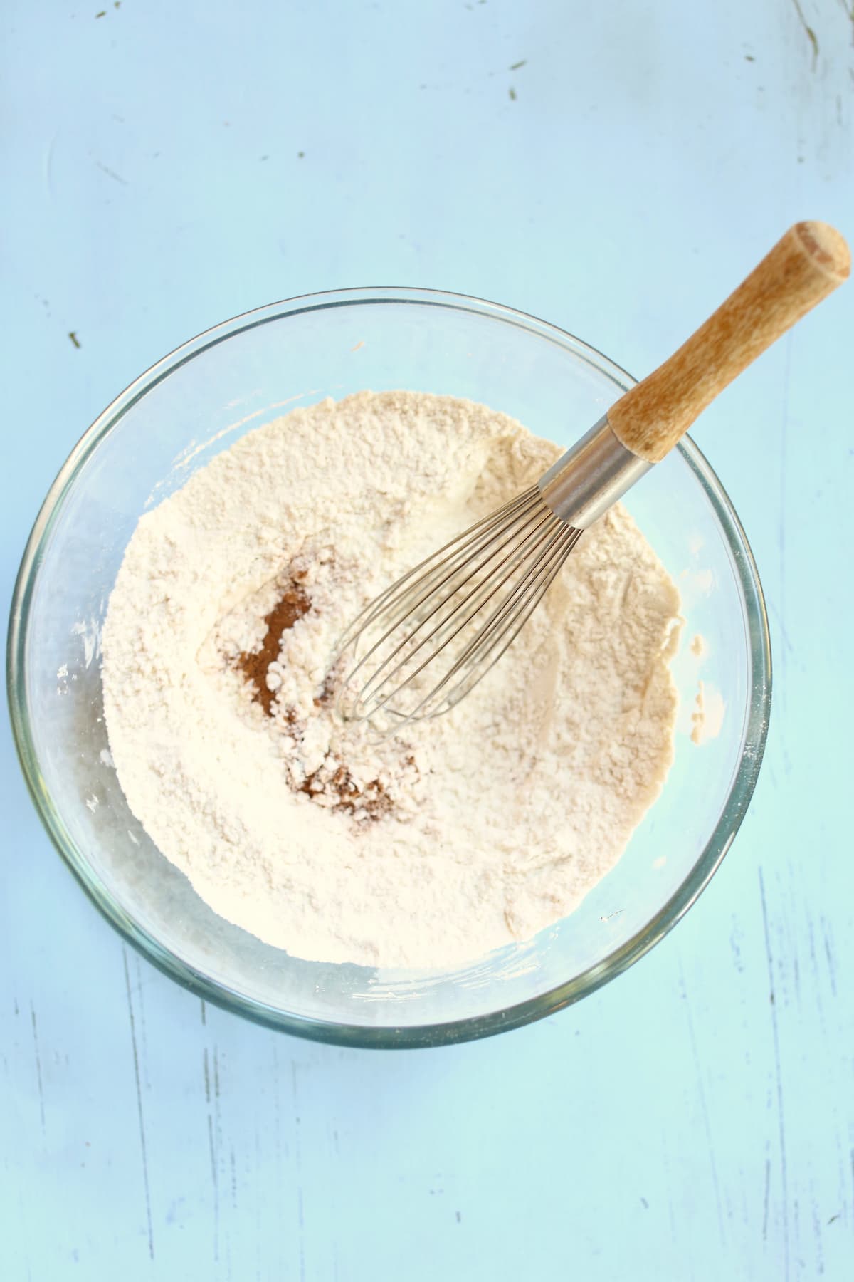a bowl of dry ingredients with a whisk.