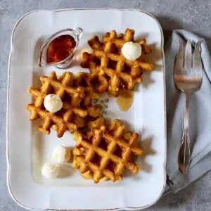 a white tray with pumpkin waffles on it.
