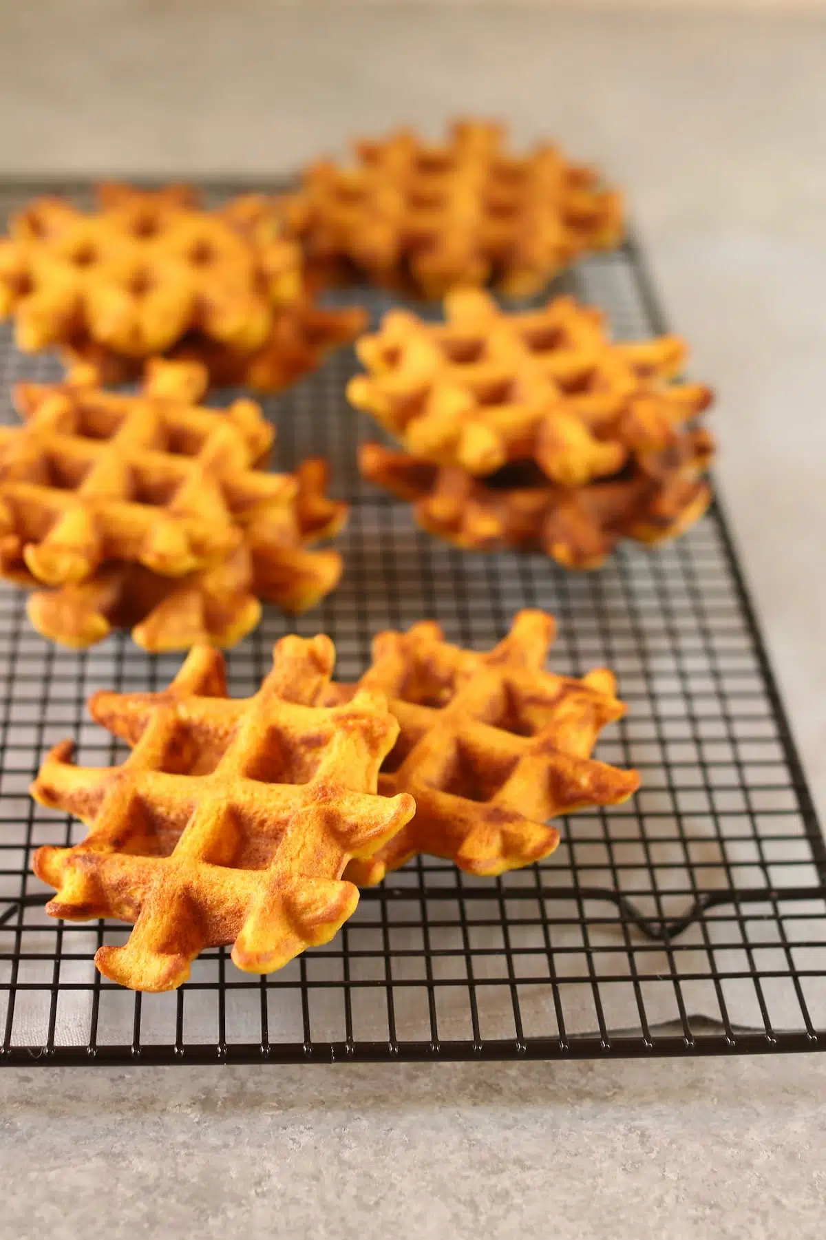 a cooking baking rack with pumpkin waffles on it.
