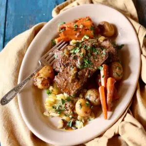 a square photo of pot roast on a plate.