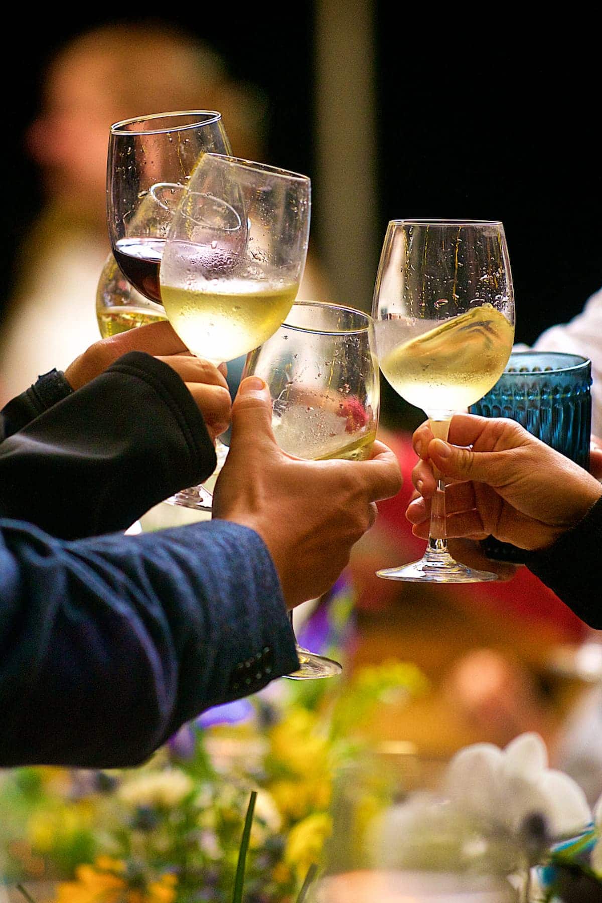 an image of people toasting with wine glasses.