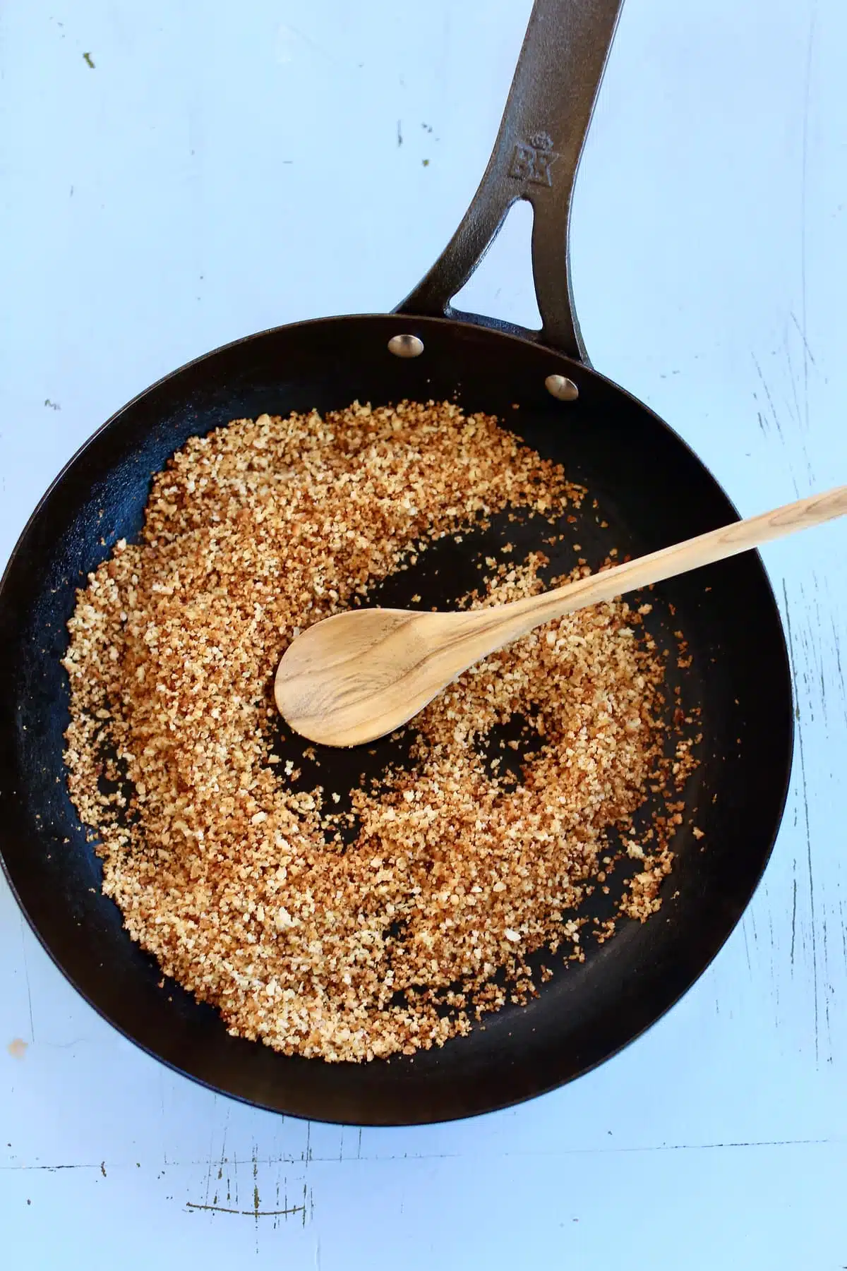 a skillet of toasted bread crumbs.