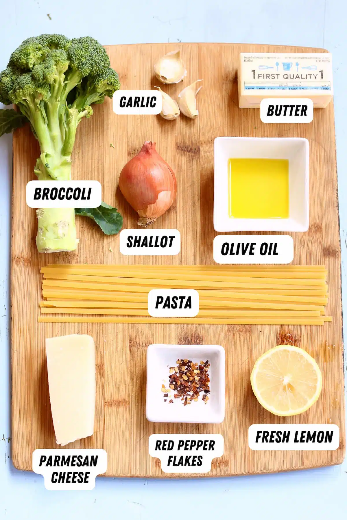 a cutting board of ingredients for pasta.