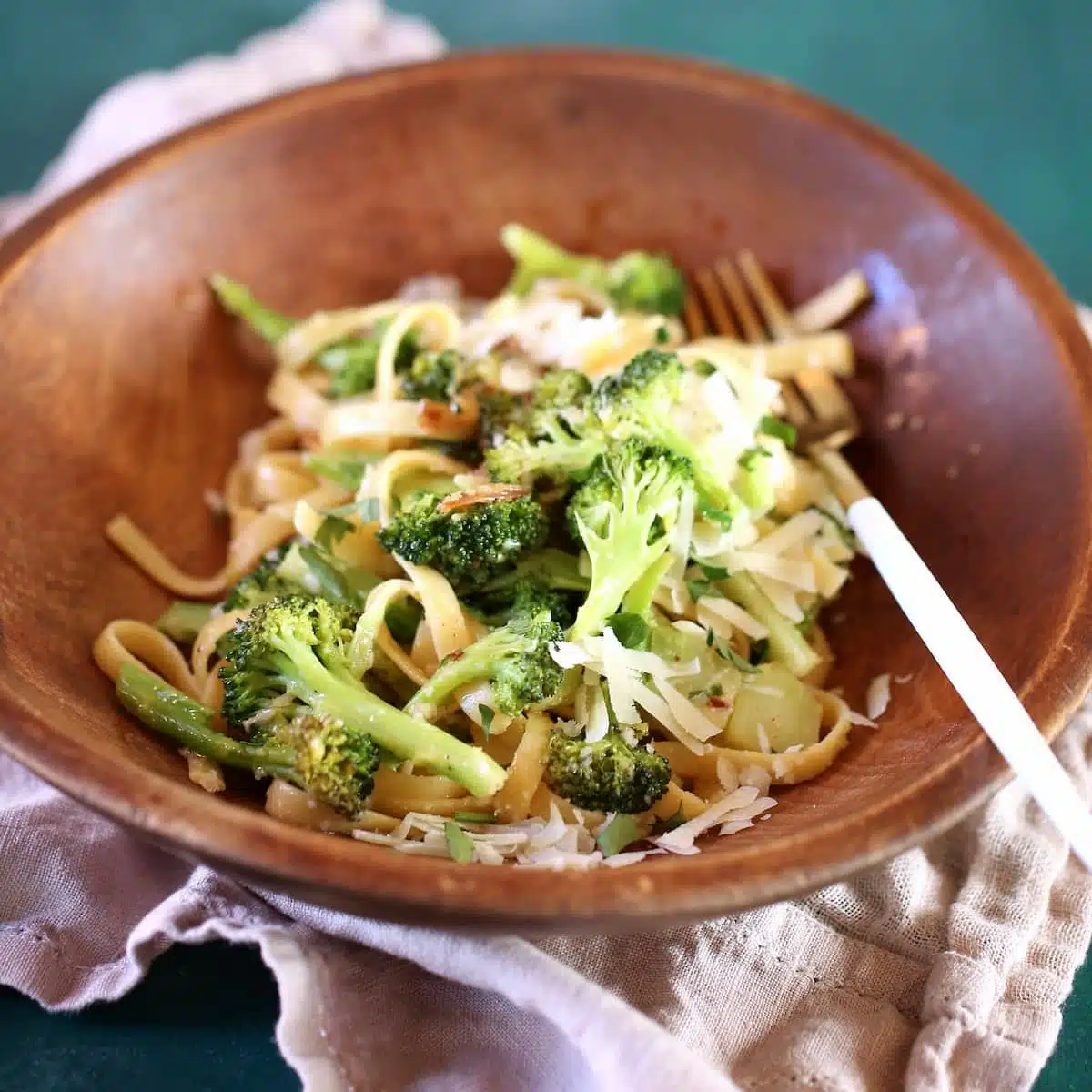 a wooden bowl of pasta a square photo.