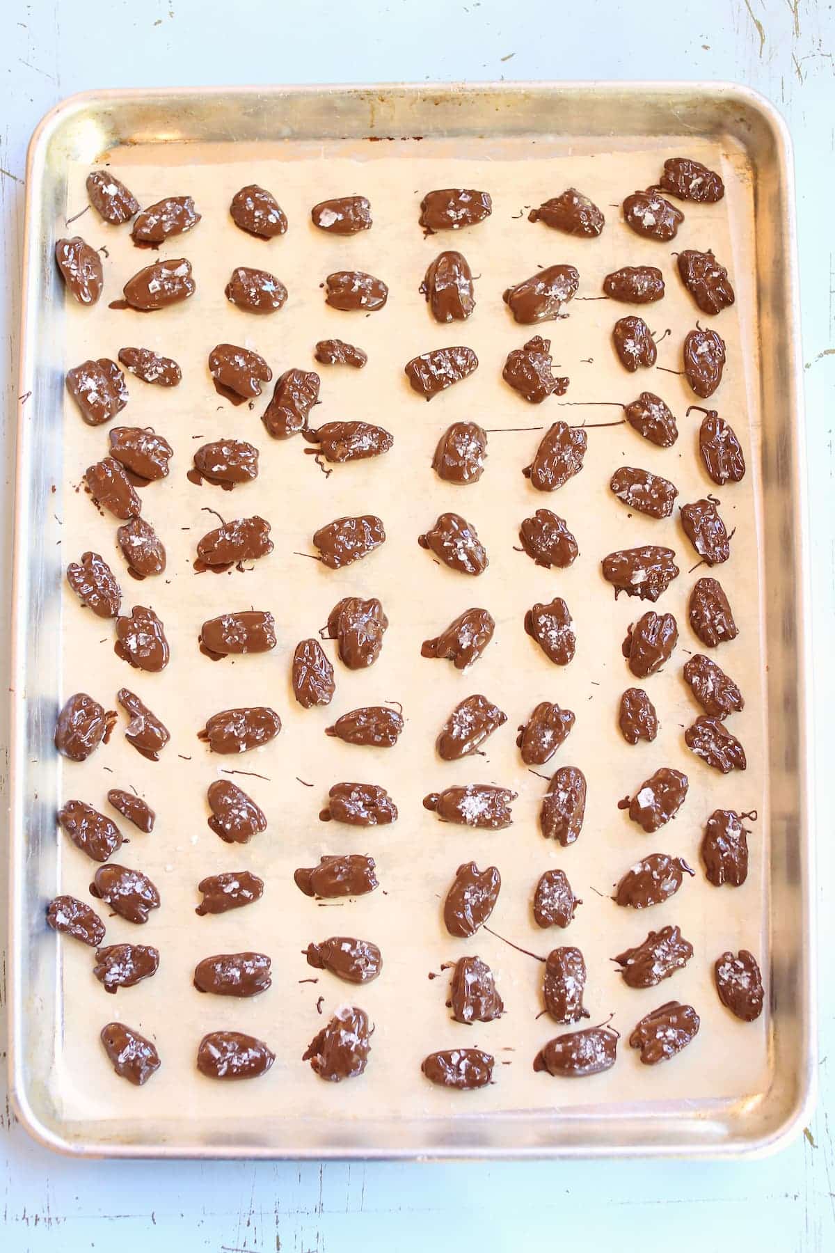 a baking sheet showing an overhead photo of pecans.
