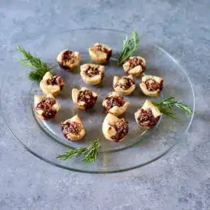 a square photo of puff pastry jam bites.