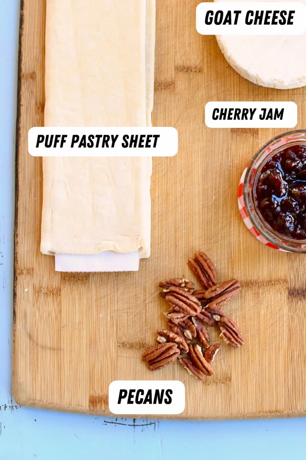 a cutting baord of puff pastry pecans and jam, labeled.