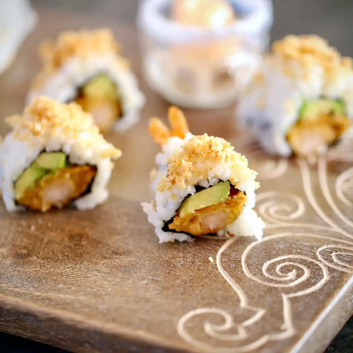 a cutting board of cut sushi rolls.