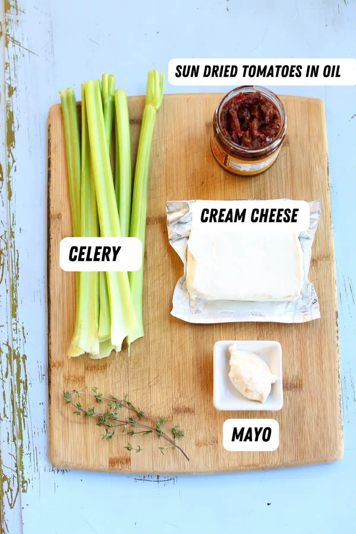 a cutting baord of ingredients for stuffed celery.