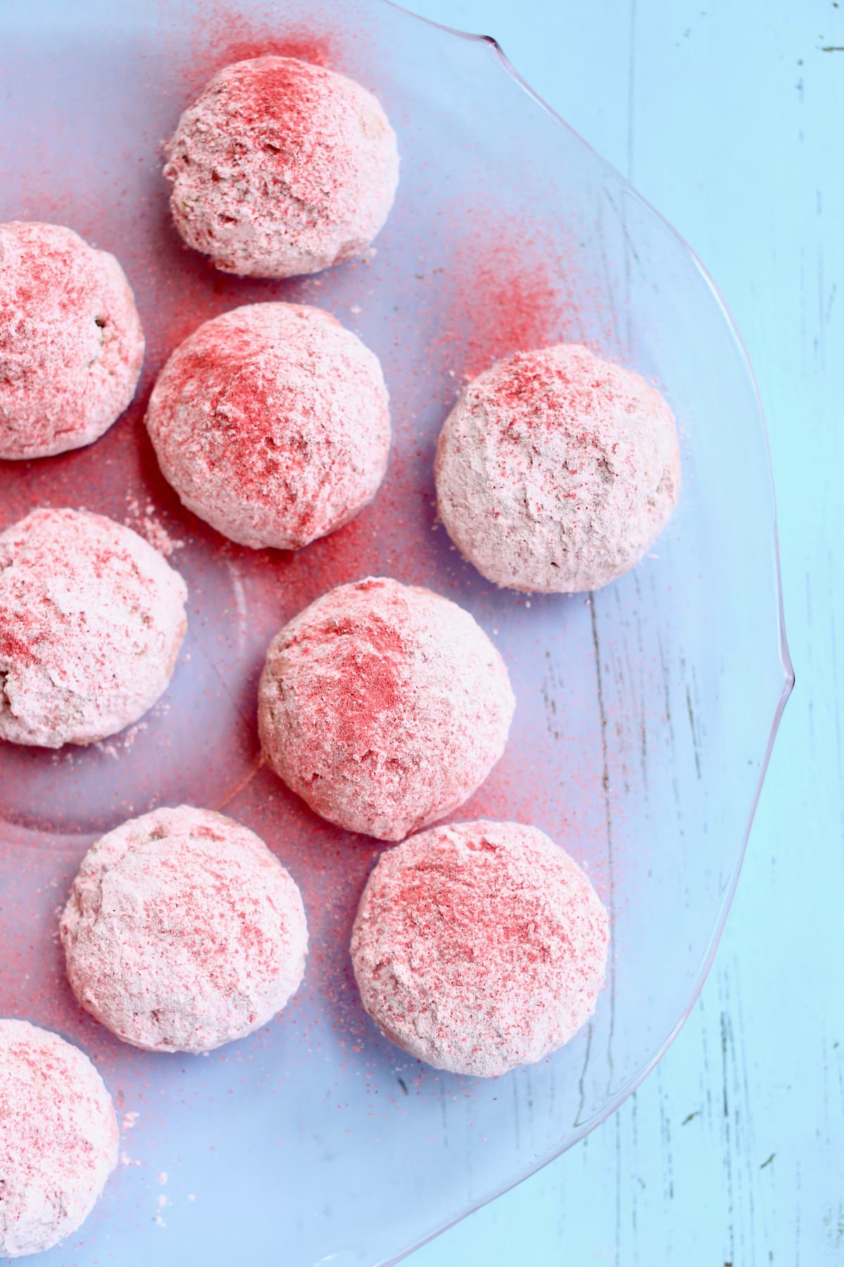 a close up of pink cookies on a tray.