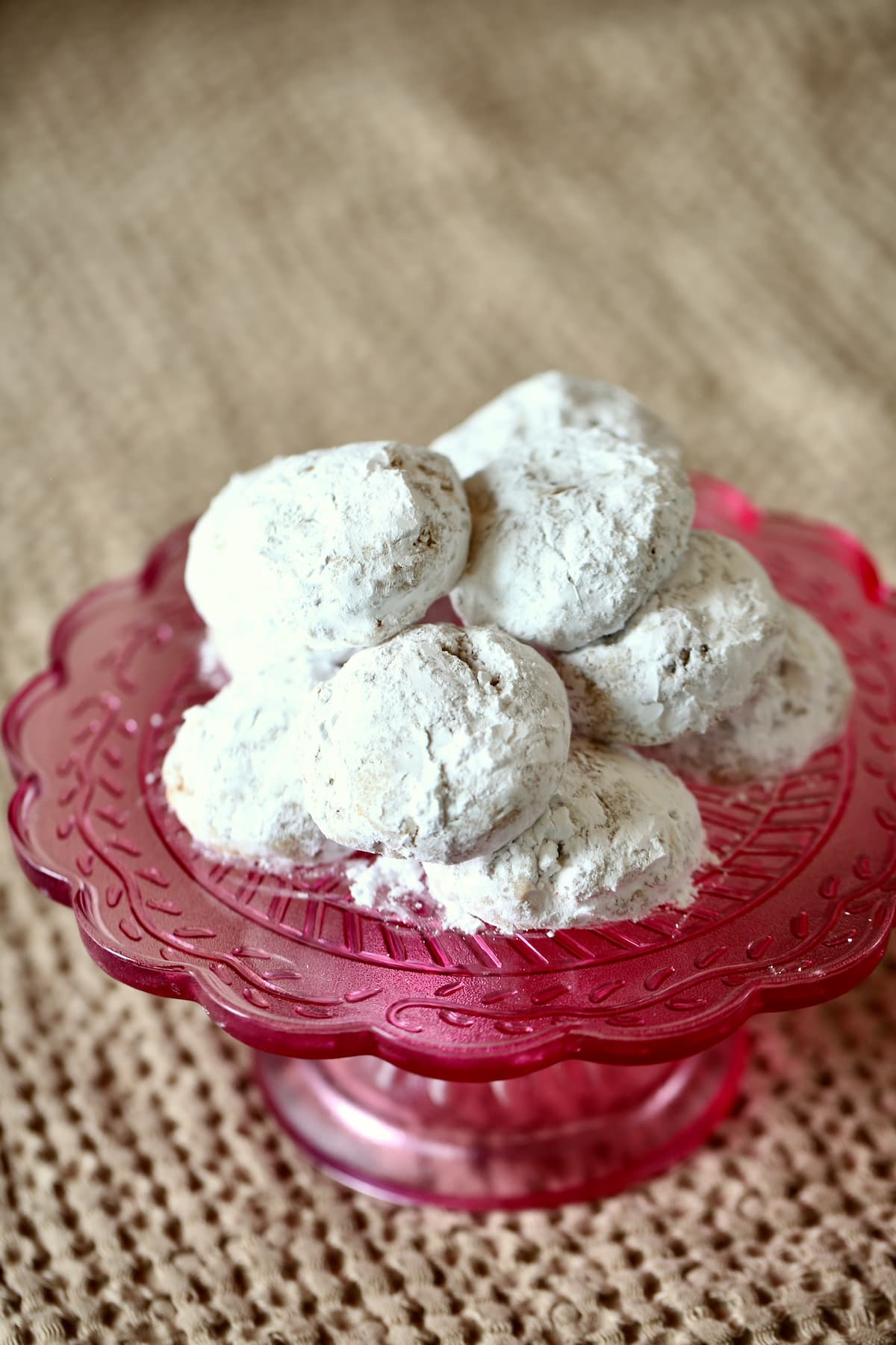a pink tray of white cookies.