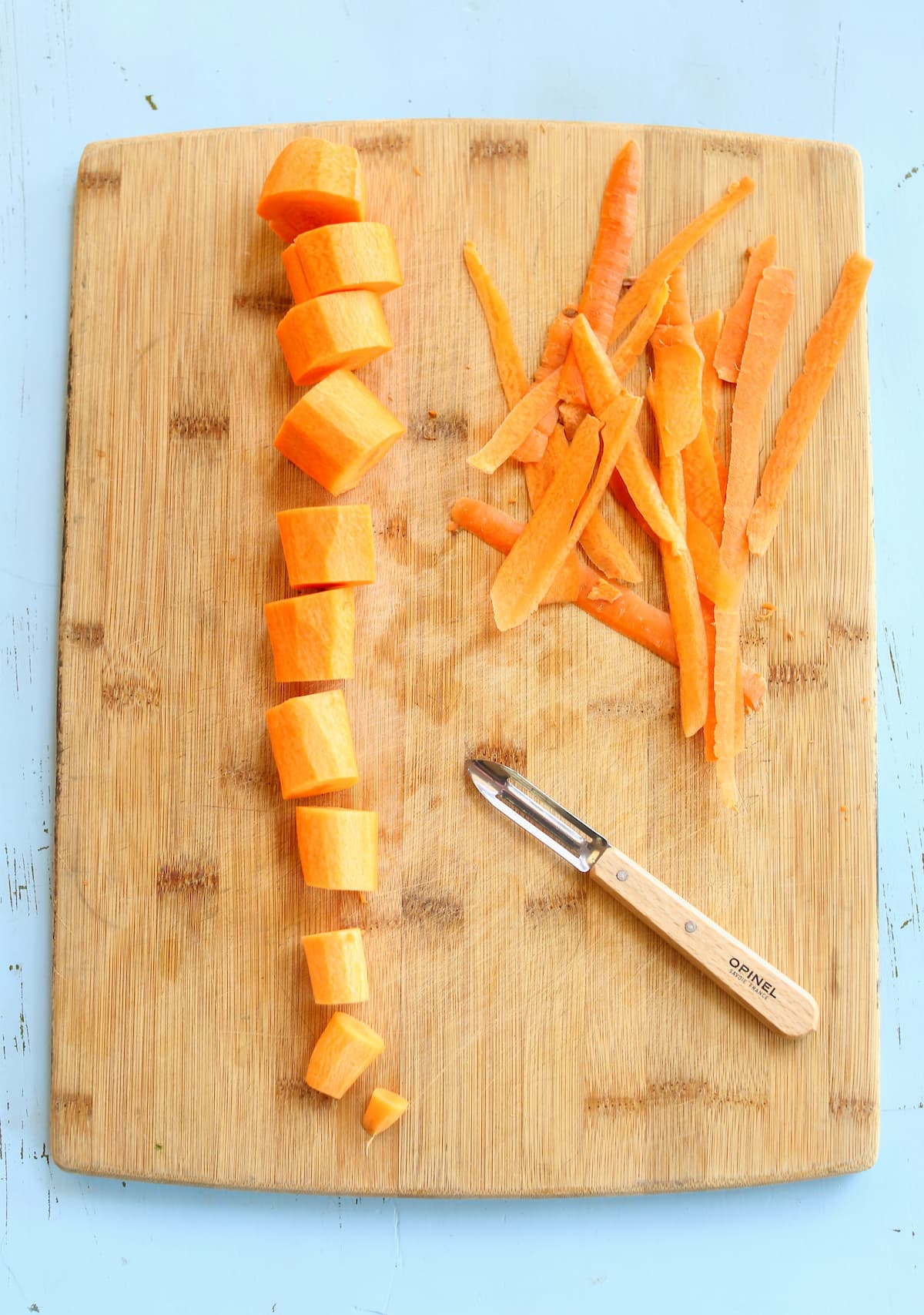 a carrot on a cutting baord, sliced.