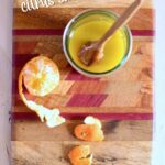 a cutting board of ingredients for maple dijon vinaigrette.