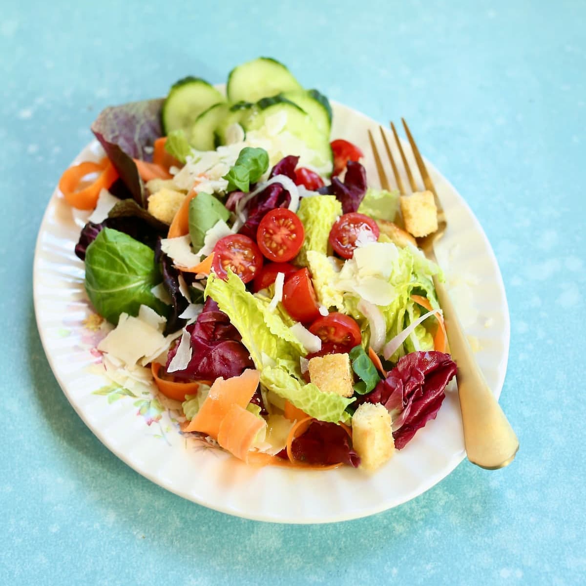 a square image of a salad on a table.